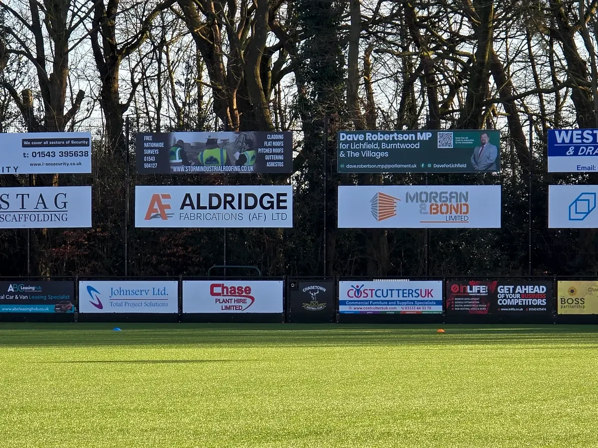 Aldridge Fabrications AF Ltd sponsorship board prominently displayed on the perimeter fence at Chasetown FC ground